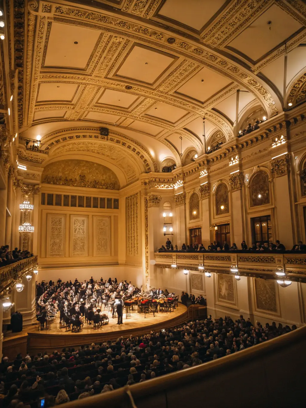 A diverse audience enjoying a chamber music performance in a community hall, highlighting the accessibility and inclusivity of the organization's events.
