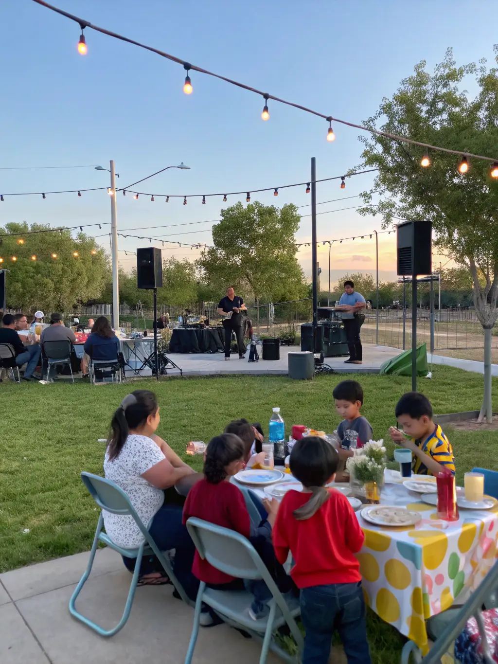 A diverse group of community members enjoying a free outdoor concert organized by the association.